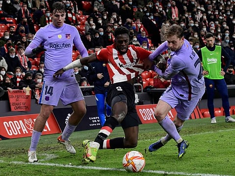 Athletic Bilbao's Inaki Williams is challenged by Barcelona's Nico Gonzalez and Frenkie de Jong during the Spanish Copa del Rey Cup round of 16 match at the San Mames stadium in Bilbao.