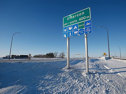 Road signage is posted just outside of Emerson, Manitoba. Investigators believe the deaths are linked to a larger human smuggling operation. 