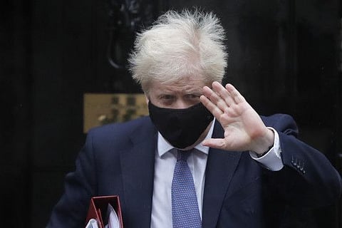Britain's Prime Minister Boris Johnson leaves Downing Street to attend the weekly session of Prime Ministers Questions at Parliament in London, Wednesday, Oct. 21, 2020.