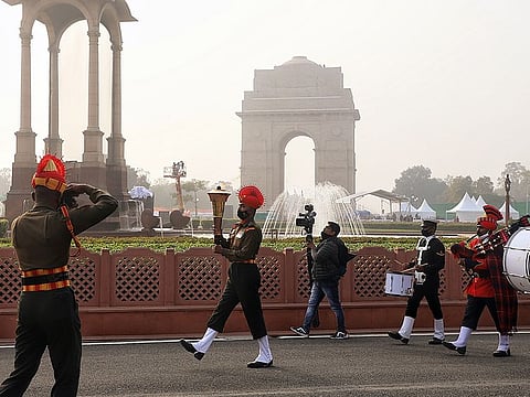 Army personnel carries torch lits with flame of Amar Jawan Jyoti to merge with the flame at the National War Memorial during a ceremony, at India Gate in New Delhi on Friday. 