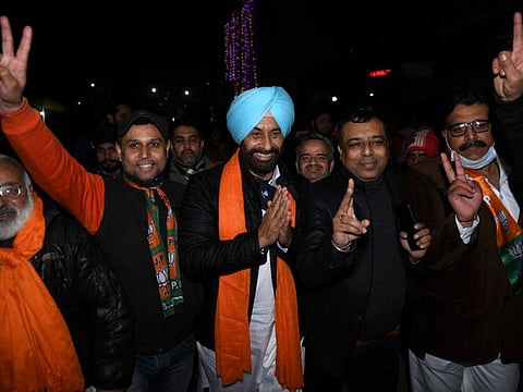 India's Bharatiya Janata Party (BJP) candidate for the upcoming Punjab state assembly elections Sukhwinder Singh Pintu (centre) during an election campaign in Amritsar on January 21, 2022. 