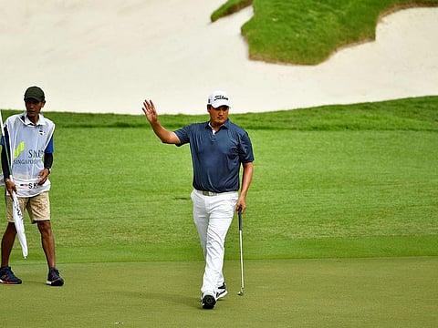 Sihwan Kim of the US gestures during round three of the SMBC Singapore Open golf tournament in Singapore. 