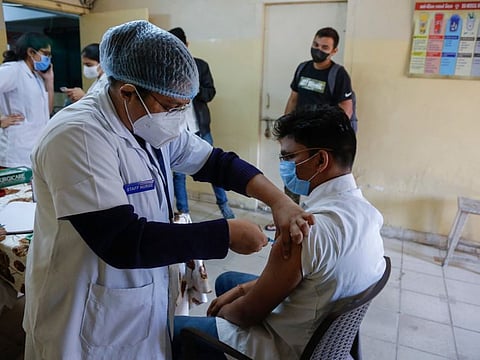 A health worker receives third dose of vaccination for COVID-19 at a vaccination centre at Civil hospital in Ahmedabad, India, Monday, Jan. 10, 2022. Healthcare and front-line workers along with people above age 60 with health problems lined up Monday at vaccination centers across India to receive a third vaccination as infections linked to the omicron variant surge. India is calling this dose a “precautionary” shot instead of a booster. 