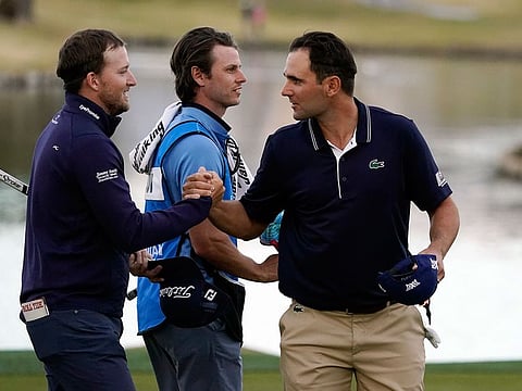 Lee Hodges and Paul Barjon shake hands at the American Express 