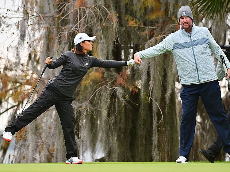 Danielle Kang fist bumps Derek Lowe 