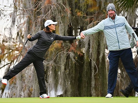 Danielle Kang fist bumps Derek Lowe 