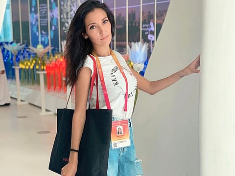 Russian national Cristina Mokrova works as a hostess at a restaurant at Expo 2020 Dubai.