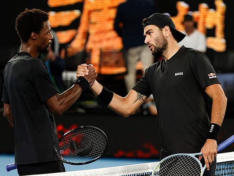 Anybody's game: Matteo Berrettini (right) of Italy with Gael Monfils, the French journeyman, after winning the epic quarter final.