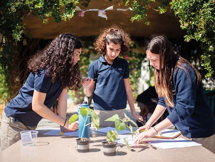 American School of Dubai students conduct an experiment in this February 2020 photo