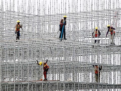 Construction workers seen on scaffolding for a bridge made for the coastal road project at Hajji Ali in Mumbai. India is focusing on infrastructure investments to bolster industrial demand 