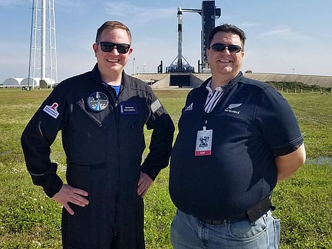 This photo provided by Kyle Hippchen shows him, right, with Chris Sembroski near launch complex 39A in Cape Canaveral, Fla., on April 21, 2021.