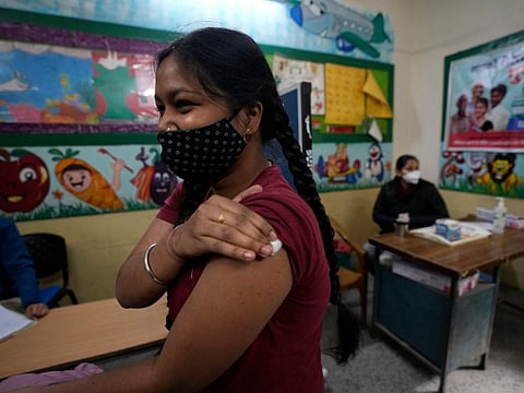 A girl leaves after receiving a COVID-19 vaccine at a government school, in New Delhi, .