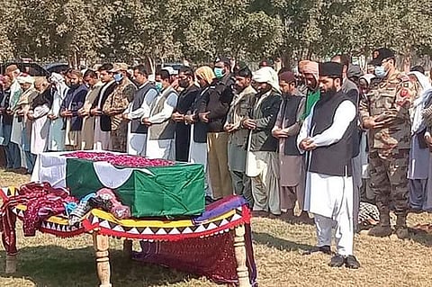 Military officials and local residents offer funeral prayers for a soldier who was killed in an attack in the Kech district of Balochistan province, in Dera Murad jamali, on January 27, 2022.