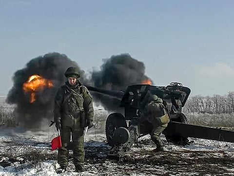 In this photo taken from video provided by the Russian Defence Ministry Press Service on January 28, 2022, Russian troops fire howitzers during drills in the Rostov region during a military exercising at a training ground in Rostov region, Russia. 