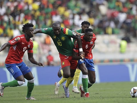 Cameroon’s Aboubakar Vincent (centre) is Challenge by Gambia’s  James Gomez (left) and Sulayman Marreh during  the African Cup of Nations 2022 quarterfinals match at Japoma Stadium, Douala, Cameroon.