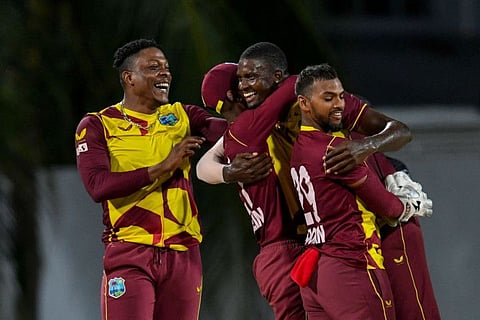 Jason Holder (centre), Sheldon Cottrell (left) and Nicholas Pooran (right) of West Indies celebrate after winning the 5th and final T20I against England at Kensington Oval, Bridgetown, Barbados.