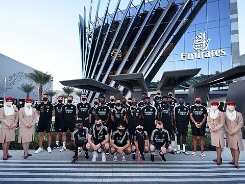 Members of Arsenal football team strike a pose with Emirates crew members during their visit of the airlines' pavilion at Expo 2020. 
