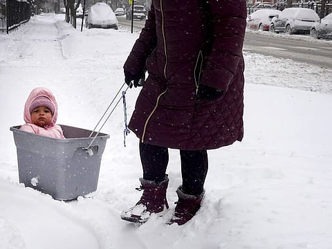 Olia is taken on a tour of her snow-covered neighbourhood by her nanny on February 02, 2022 in Chicago, Illinois. 