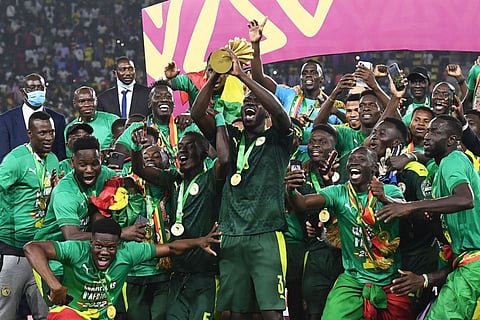 Senegal's players celebrate with the trophy after winning the Africa Cup of Nations (CAN) 2021 final against Egypt at Stade d'Olembe in Yaounde.