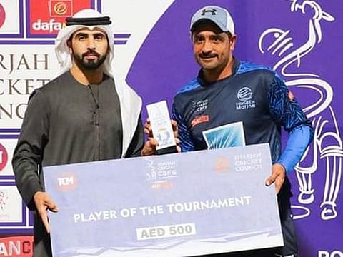 Asif Khan receives the player of the tournament award from Khalaf Bukhatir during the awards ceremony for the CBFS powered Fancode Twenty20 tournament at the Sharjah Cricket Stadium recently.