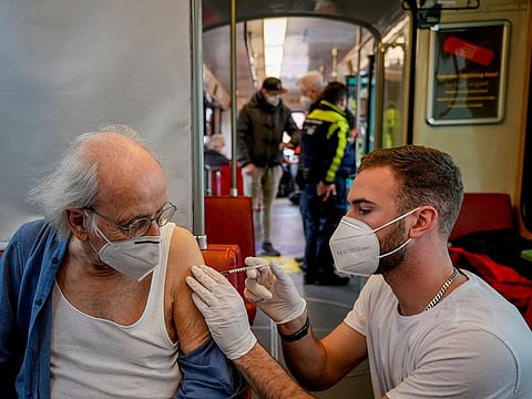 A 85-year-old man receives a booster vaccination in the so called "vaccination express" tram in central Frankfurt