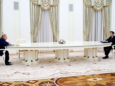 Russian President Vladimir Putin, left, listens to French President Emmanuel Macron during their meeting in the Kremlin in Moscow, Russia, Feb. 7, 2022. 
