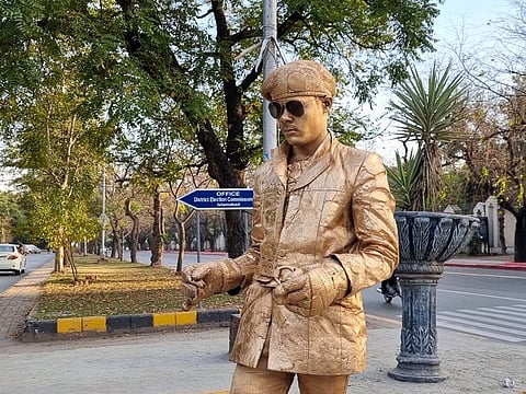 The ‘Golden Man of Islamabad’ stands near the famous Jinnah Super Market in Islamabad.  