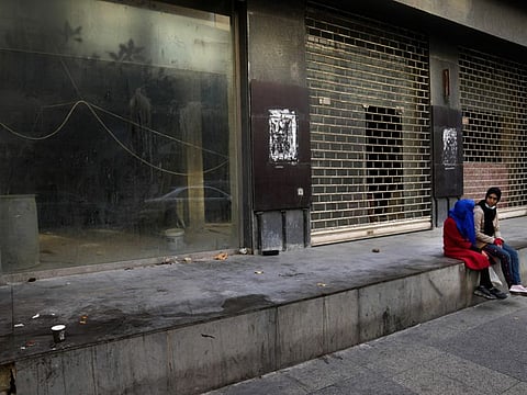 Beggars sit in front of shops that close for ever after the economy crisis, at the commercial Hamra Street, in Beirut. Hamra Street once was home to the region's top movie theatres, shops selling international brands and cafes where intellectuals from around the Arab world gathered. Today, it reflects Lebanon's devastating multiple crises.