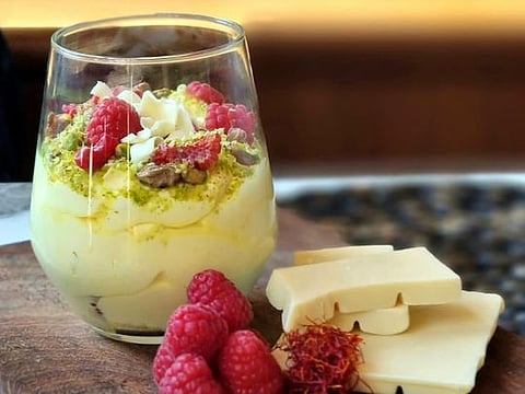 White chocolate mousse with saffron, raspberries and pistachios 