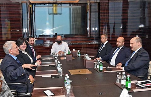 A handout picture obtained from the Israeli Government Press Office on February 15, 2022 shows Israeli Prime Minister Naftali Bennett (R) meeting with the Bahraini Jewish community leaders in Manama. 
