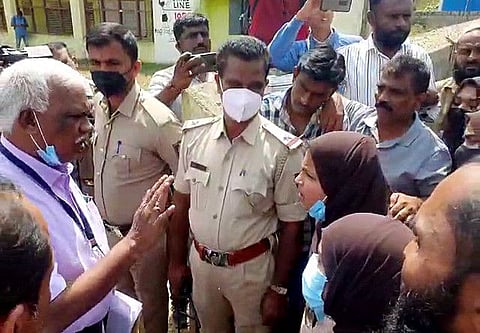 School management staff in an argument with students after they were not allowed to enter the school premises wearing headscarves (hijab), at Government High School, Indavara, in Chikmagalur on Tuesday. 