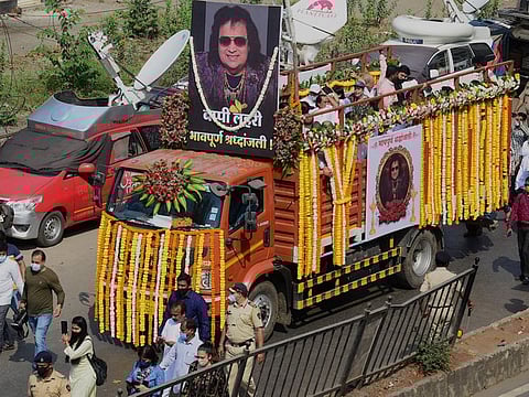 People march during the funeral procession of late Indian singer-composer Bappi Lahiri in Mumbai on February 17, 2022.