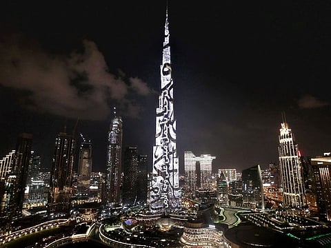 Burj Khalifa lit up in dazzling display of Arabic calligraphy to welcome the soon-to-open Museum of the Future.