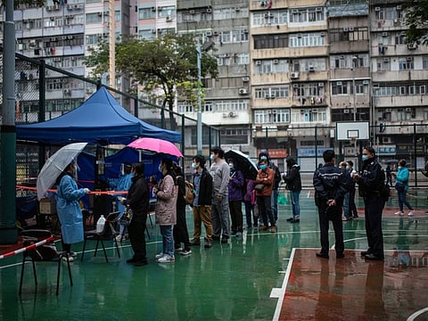 Residents queue at a COVID-19 testing facility in Hong Kong on Thursday, Feb. 17, 2022.