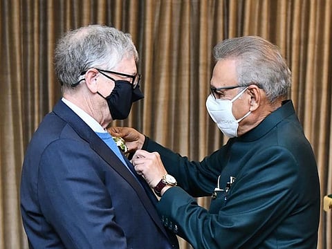 This handout photograph taken and released by Pakistan's Press Information Department (PID) on February 17, 2022, shows Pakistan's President Arif Alvi (R) confers the country's second highest civilian award, Hilal-e-Pakistan, on American Microsoft founder-turned-philanthropist Bill Gates, in recognition of his services for the eradication of polio and the betterment of the people of Pakistan, at the President House in Islamabad. 