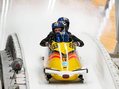 Johannes Lochner of Germany and his team finish during the four-man bobsleigh training heat at the 2022 Winter Olympics on Thursday.