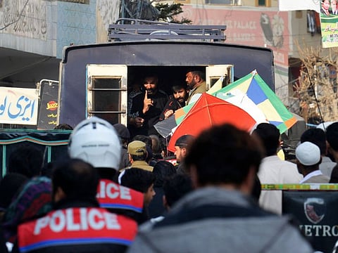 Policemen arrest kite flyers during the Basant Kite Festival as a ban was imposed by authorities in 2007 following a spate of accidents, in Rawalpindi on February 18, 2022. 