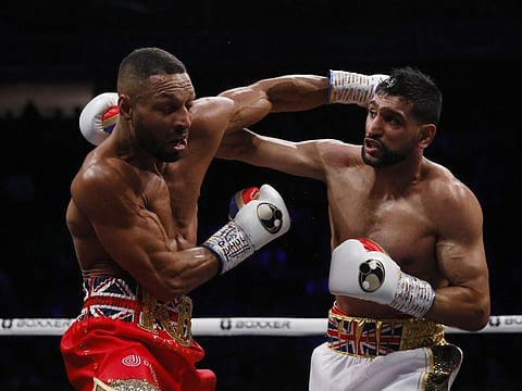 Amir Khan (right) in action against Kell Brook at the Manchester Arena, England.