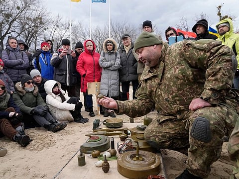 An instructor, right, shows a grenade during a training of members of a Ukrainian far-right group train, in Kyiv on February 20, 2022. 