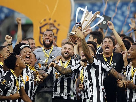 Atletico Mineiro players celebrate with the trophy after winning the final.