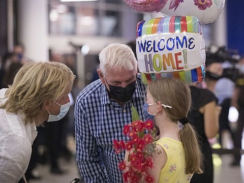 A girl with balloons and flowers at the arrival hall at the international terminal of Sydney Airport in Sydney, Australia, on Monday, Feb. 21, 2022.
