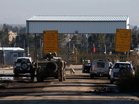 An Israeli military vehicle and United Nations Disengagement Observer Force (UNDOF) cars are pictured at the United Nations Quneitra crossing with Syria and the Israeli-annexed Golan Heights on February 9, 2022.