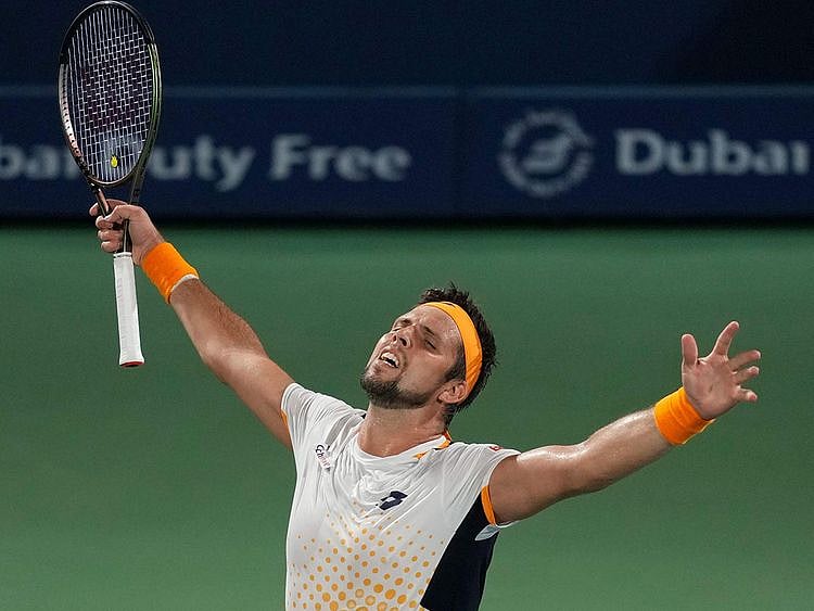 Jiri Vesely celebrates after beating Denis Shapovalov at the Dubai Duty Free Tennis Championships