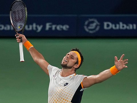 Jiri Vesely celebrates after beating Denis Shapovalov at the Dubai Duty Free Tennis Championships