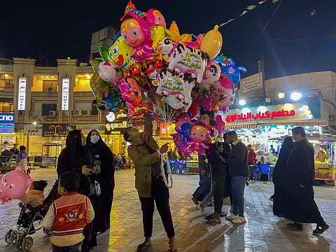 A street vendor sells balloons and toys at Kadhimiya district in, Baghdad, on Friday, February 18, 2022.  Fewer than 10 million people in Iraq, about a quarter of the population, have been vaccinated, said health ministry spokesman Seif Al Badr.
