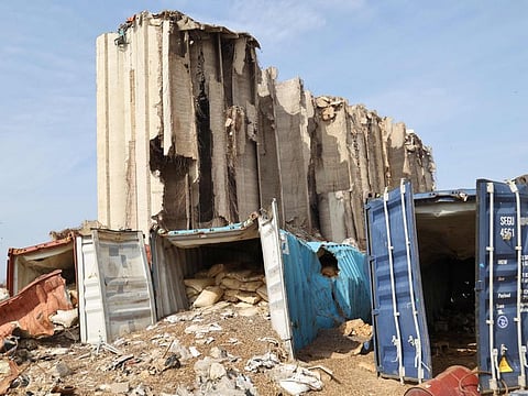A photo taken on February 17, 2022 shows a general view of Beirut port's damaged grain silos behind destroyed containers, a year and a half after a deadly explosion there killed more than 200 people and destroyed large parts of the Lebanese capital. French shipping giant CMA CGM has won a 10-year contract beginning in March to run the container terminal at Beirut port, Lebanon's public works and transport minister said. The contract will provide the cash-strapped state "tens of millions of dollars" every year, he said, adding that authorities chose the French company over its UAE-based competitor Gulftainer because it offered a better rate and more favourable conditions. 