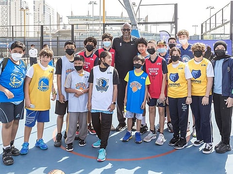 10-time NBA All-Star Clyde Drexler  with some of the school children with their respective jerseys during the announcement of the Jr. NBA Legue, to begin in Abu Dhabi on March 5.