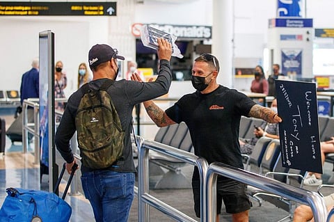 Passengers and loved ones reunite at the arrivals hall on the first day of New Zealanders returning from Australia after the border reopened for travellers observing home self-isolation rules, at the Auckland international airport on February 28, 2022.