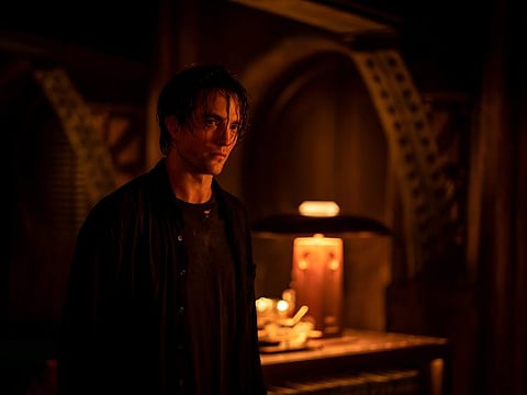 This image released by Warner Bros. Pictures shows Robert Pattinson in a scene from "The Batman."