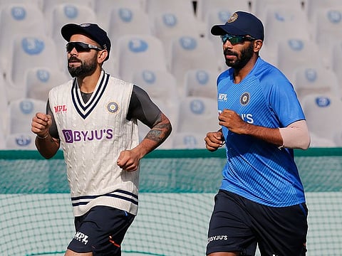 Virat Kohli (left) and Jasprit Bumrah go through their paces as the Indian squad began their practice at Mohali Stadium on Monday.